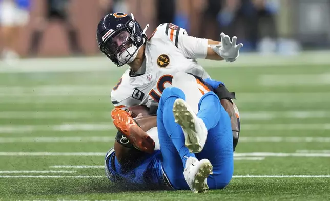 Chicago Bears quarterback Caleb Williams (18) is sacked by Detroit Lions linebacker Al-Quadin Muhammad (69) during the second half of an NFL football game in Detroit, Thursday, Nov. 28, 2024. (AP Photo/Carlos Osorio)