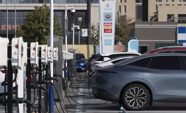 Electric vehicle charging stations are seen in Beijing, Friday, Oct. 11, 2024. (AP Photo/Caroline)