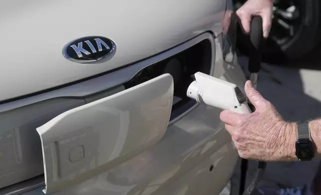 Ken Honeycutt demonstrates charging his Kia Soul electric vehicle in San Lorenzo, Calif., Saturday, Nov. 9, 2024. (AP Photo/Jeff Chiu)