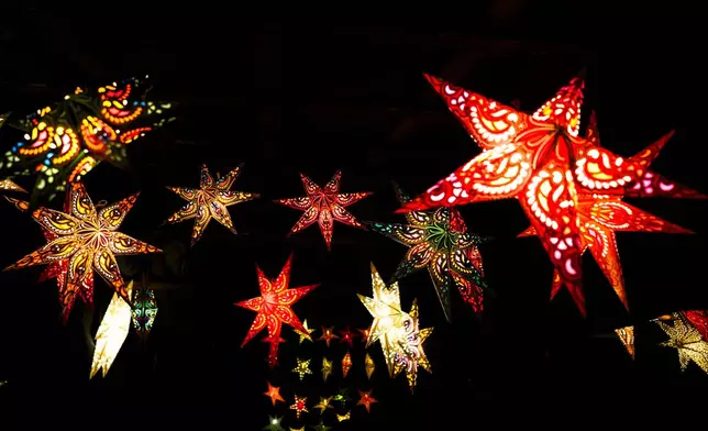 Christmas stars for decoration displayed in a shop at the "Lucia" Christmas Market at the district Prenzlauer Berg in Berlin, Germany, Monday, Nov. 25, 2024. (AP Photo/Markus Schreiber)