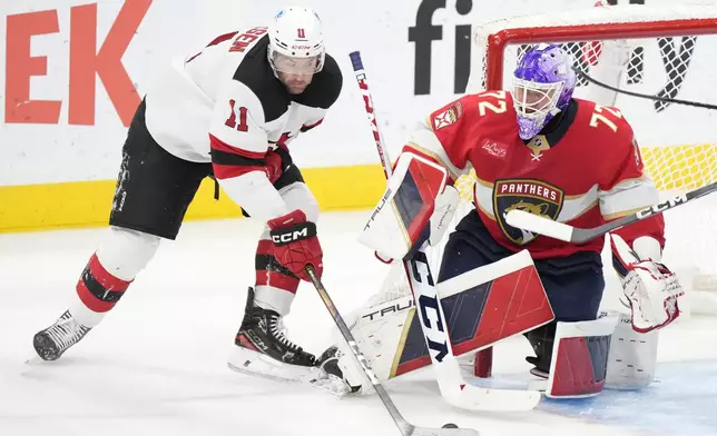 New Jersey Devils right wing Stefan Noesen (11) attempts a shot at Florida Panthers goaltender Sergei Bobrovsky (72) during the second period of an NHL hockey game, Thursday, Nov. 14, 2024, in Sunrise, Fla. (AP Photo/Wilfredo Lee)