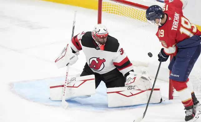 Florida Panthers left wing Matthew Tkachuk (19) attempts a shot against New Jersey Devils goaltender Jake Allen (34) during the second period of an NHL hockey game, Thursday, Nov. 14, 2024, in Sunrise, Fla. (AP Photo/Wilfredo Lee)