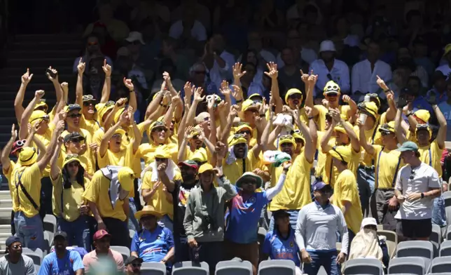 Australia's fans celebrate their team's hundred runs on the second day of the first cricket test between Australia and India in Perth, Australia, Saturday, Nov. 23, 2024. (AP Photo/Trevor Collens)