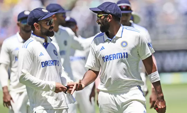 India's captain Jasprit Bumrah, right, and teammate Virat Kohli as they leave the field at the end of the first innings on the second day of the first cricket test between Australia and India in Perth, Australia, Saturday, Nov. 23, 2024. (AP Photo/Trevor Collens)