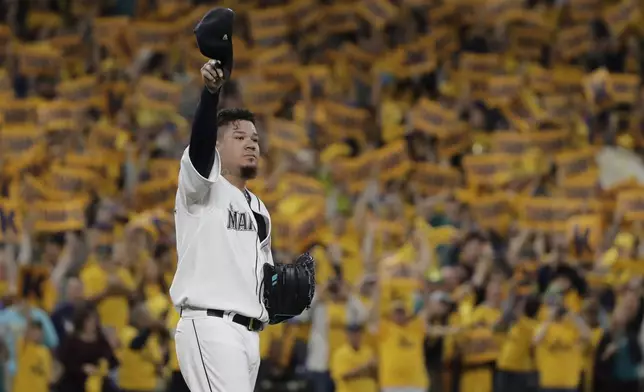 FILE - With the "King's Court" cheering section behind him, Seattle Mariners starting pitcher Félix Hernández tips his cap as he takes the mound for the team's baseball game against the Oakland Athletics, Sept. 26, 2019, in Seattle. (AP Photo/Ted S. Warren, File)