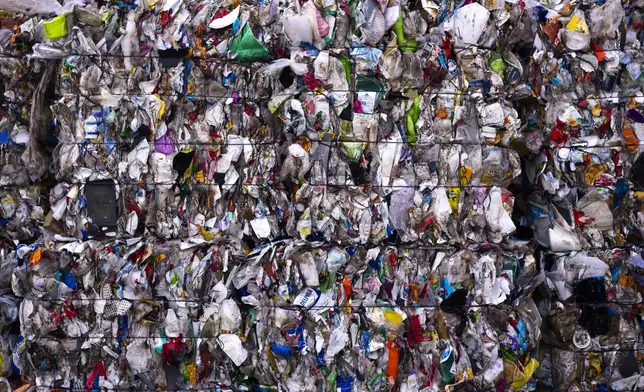 Plastic garbage bales stand at the courtyard of the Interzero plastic sorting facility facility in Berlin, Germany, Wednesday, Nov. 27, 2024. (AP Photo/Markus Schreiber)