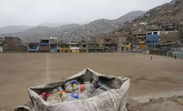 Plastic bottles collected from garbage dumps and streets by recycler Jorge Tejada fill a bag, in Lima, Peru, Tuesday, Nov. 26, 2024. (AP Photo/Guadalupe Pardo)