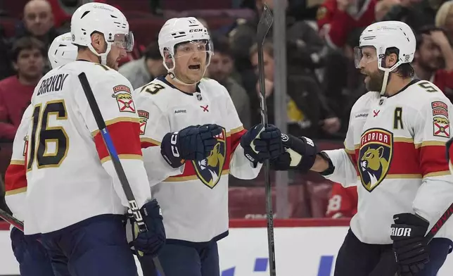 Florida Panthers center Sam Reinhart, center, celebrates his goal on the Chicago Blackhawks during the second period of an NHL hockey game Thursday, Nov. 21, 2024, in Chicago. (AP Photo/Erin Hooley)