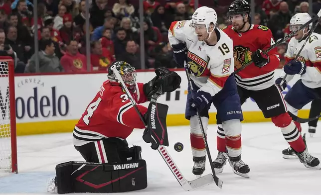 Chicago Blackhawks goaltender Petr Mrazek deflects the puck back toward Florida Panthers left wing Matthew Tkachuk during the second period of an NHL hockey game Thursday, Nov. 21, 2024, in Chicago. (AP Photo/Erin Hooley)