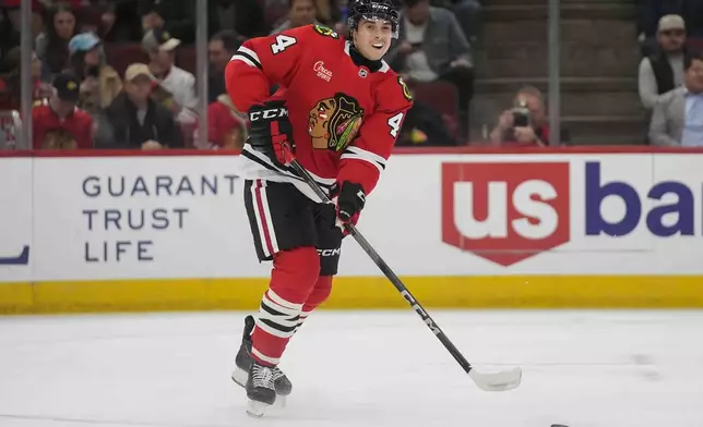 Chicago Blackhawks defenseman Wyatt Kaiser passes the puck during the first period of an NHL hockey game against the Florida Panthers, Thursday, Nov. 21, 2024, in Chicago. (AP Photo/Erin Hooley)