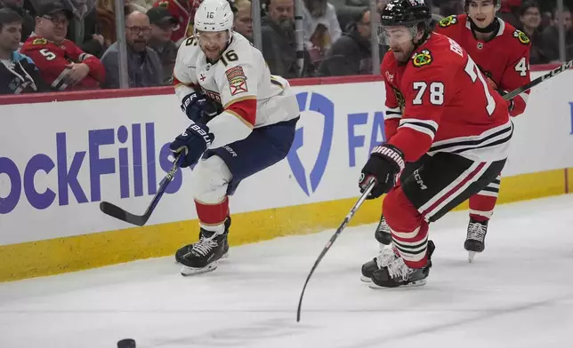 Florida Panthers center Aleksander Barkov, left, and Chicago Blackhawks defenseman TJ Brodie (78) chase the puck during the first period of an NHL hockey game Thursday, Nov. 21, 2024, in Chicago. (AP Photo/Erin Hooley)