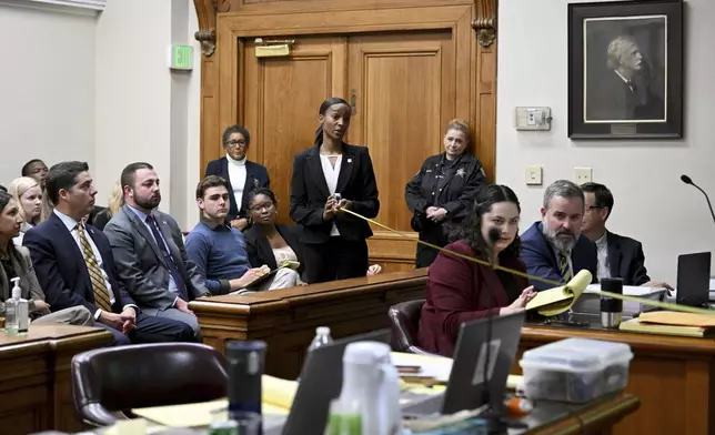 GBI Crime Scene Specialist Daniella Stuart, center, takes a measurement as she testifies during a trial of Jose Ibarra, accused of killing a Georgia nursing student earlier this year, at Athens-Clarke County Superior Court, Friday, Nov. 15, 2024, in Athens, Ga.(Hyosub Shin/Atlanta Journal-Constitution via AP, Pool)