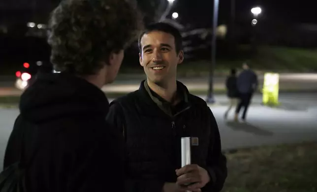 FILE - Republican congressional candidate Austin Theriault, right speaks with Carlos Kennelly, left, Tuesday, Nov. 5, 2024 outside the Cross Insurance Center in Bangor, Maine. (AP Photo/Joel Page, File)