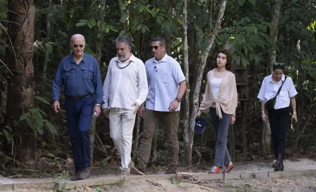 President Joe Biden, from left, walks with Henrique Pereira, director of the National Institute for Research in the Amazon, granddaughter Natalie Biden, second right, and daughter Ashley Biden, right, during a tour of the Museu da Amazonia in Manaus, Brazil, Sunday, Nov. 17, 2024. (AP Photo/Manuel Balce Ceneta)