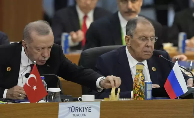 Turkey's President Recep Tayyip Erdogan, left, and Russia's Foreign Minister Sergey Lavrov attend the G20 Summit leaders meeting in Rio de Janeiro, Monday, Nov. 18, 2024. (AP Photo/Eraldo Peres)