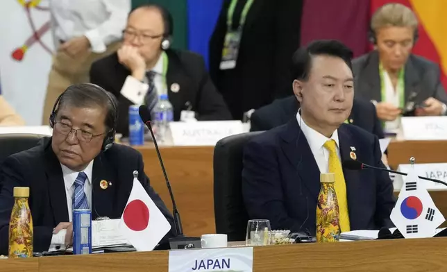 Japan's Prime Minister Shigeru Ishiba, left, and South Korea's President Yoon Suk Yeol attend the G20 Summit leaders meeting in Rio de Janeiro, Monday, Nov. 18, 2024. (AP Photo/Eraldo Peres)