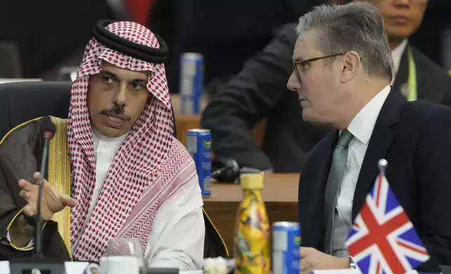 Britain's Prime Minister Keir Starmer, right, and Saudi Arabia's Foreign Minister Prince Faisal bin Farhan Al-Saud talk during the G20 Summit leaders meeting in Rio de Janeiro, Monday, Nov. 18, 2024. (AP Photo/Eraldo Peres)