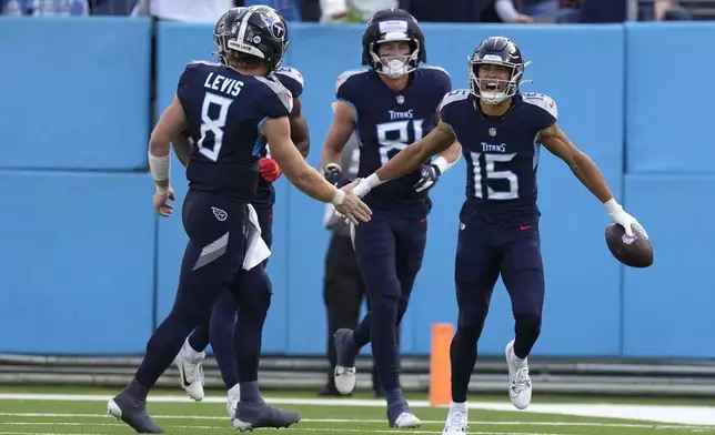 Tennessee Titans wide receiver Nick Westbrook-Ikhine (15) celebrates with teammate quarterback Will Levis (8) after catching a 98-yard touchdown pass during the second half of an NFL football game against the Minnesota Vikings, Sunday, Nov. 17, 2024, in Nashville, Tenn. (AP Photo/George Walker IV)