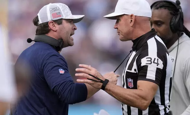 Tennessee Titans head coach Brian Callahan, left, questions a call with referee Clete Blakeman (34) during the first half of an NFL football game against the Minnesota Vikings, Sunday, Nov. 17, 2024, in Nashville, Tenn. (AP Photo/George Walker IV)