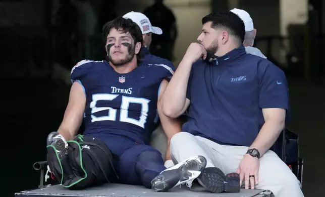 Tennessee Titans linebacker Jack Gibbens (50) is carted off the field after getting injured during the second half of an NFL football game against the Minnesota Vikings, Sunday, Nov. 17, 2024, in Nashville, Tenn. (AP Photo/George Walker IV)