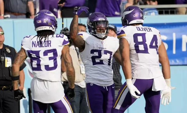 Minnesota Vikings running back Cam Akers (27) celebrates after catching a touchdown pass during the second half of an NFL football game against the Tennessee Titans, Sunday, Nov. 17, 2024, in Nashville, Tenn. (AP Photo/George Walker IV)