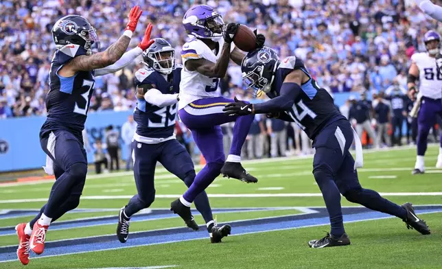 Minnesota Vikings wide receiver Jordan Addison (3) is hit by Tennessee Titans safety Mike Brown, right, while reaching for an incomplete pass during the first half of an NFL football game, Sunday, Nov. 17, 2024, in Nashville, Tenn. (AP Photo/John Amis)