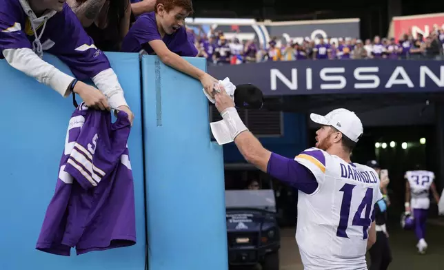 Minnesota Vikings quarterback Sam Darnold greets fans after an NFL football game against the Tennessee Titans, Sunday, Nov. 17, 2024, in Nashville, Tenn. (AP Photo/George Walker IV)