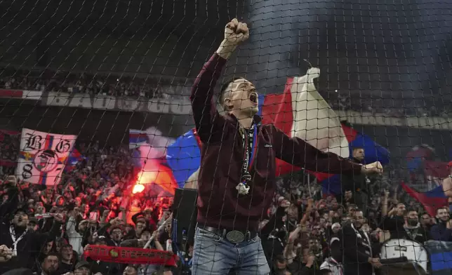 Fans of Lyon celebrate victory after the French League One soccer match between Lyon and Saint-Etienne at the Groupama stadium in Decines, outside Lyon, France, Sunday, Nov. 10, 2024. (AP Photo/Laurent Cipriani)