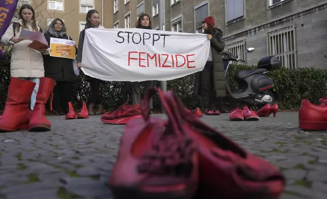 Red shoes placed on the ground as a symbol against the violence on women during a rally marking the International Day for the Elimination of Violence Against Women in Berlin, Germany, Monday, Nov. 25, 2024. (AP Photo/Markus Schreiber)