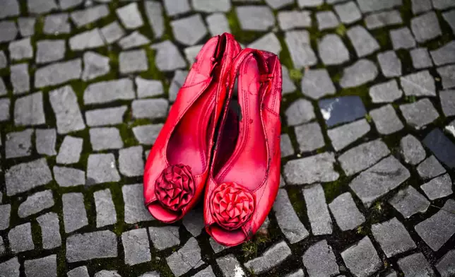 Red shoes placed on the ground as a symbol against the violence on women, during a rally marking the International Day for the Elimination of Violence Against Women in Berlin, Germany, Monday, Nov. 25, 2024. (AP Photo/Markus Schreiber)