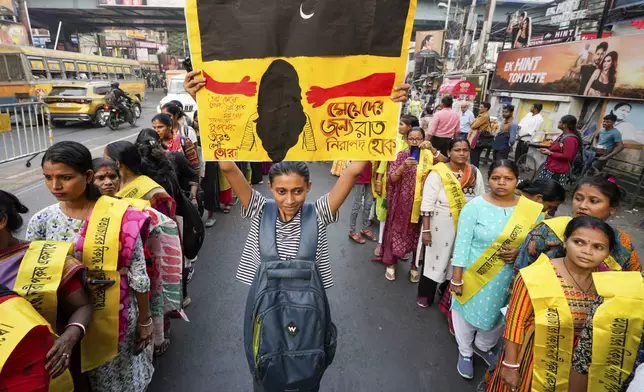 Activists from different non-government organisations shout slogans as they stage a rally to mark the International Day for the Elimination of Violence against Women, in Kolkata, India, Monday, Nov. 25, 2024. Poster in the middle read in Bangla, let the nights be safe for women. (AP Photo/Bikas Das)