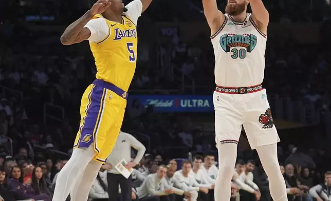 Memphis Grizzlies center Jay Huff (30) shoots over Los Angeles Lakers forward Cam Reddish (5) during the first half of an NBA basketball game Wednesday, Nov. 13, 2024, in Los Angeles. (AP Photo/Marcio Jose Sanchez)