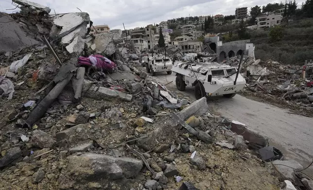 A South Korean U.N peacekeeper patrol drive past destroyed buildings in Chehabiyeh village, southern Lebanon, Thursday, Nov. 28, 2024 following a ceasefire between Israel and Hezbollah that went into effect on Wednesday. (AP Photo/Hussein Malla)