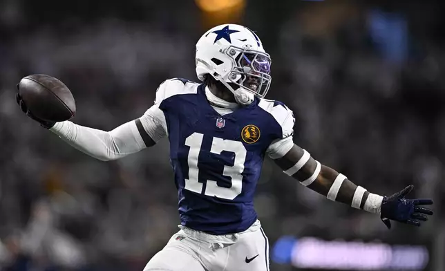 Dallas Cowboys linebacker DeMarvion Overshown (13) celebrates as he runs in for a touchdown on an interception against the New York Giants during the first half of an NFL football game in Arlington, Texas, Thursday, Nov. 28, 2024. (AP Photo/Jerome Miron)