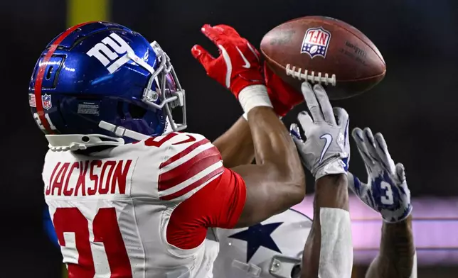 New York Giants cornerback Adoree' Jackson (21) breaks up a pass to Dallas Cowboys wide receiver Jonathan Mingo (81) during the second half of an NFL football game in Arlington, Texas, Thursday, Nov. 28, 2024. (AP Photo/Jerome Miron)