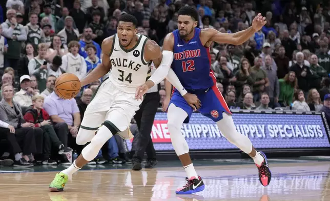 Milwaukee Bucks' Giannis Antetokounmpo gets past Detroit Pistons' Tobias Harris during the second half of an NBA basketball game Wednesday, Nov. 13, 2024, in Milwaukee. (AP Photo/Morry Gash)