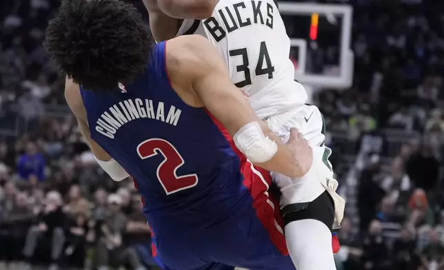 Detroit Pistons' Cade Cunningham fouls Milwaukee Bucks' Giannis Antetokounmpo during the second half of an NBA basketball game Wednesday, Nov. 13, 2024, in Milwaukee. (AP Photo/Morry Gash)