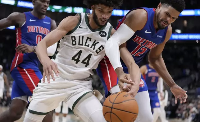 Milwaukee Bucks' Andre Jackson Jr. and Detroit Pistons' Tobias Harris go after a loose ball during overtime of an NBA basketball game Wednesday, Nov. 13, 2024, in Milwaukee. (AP Photo/Morry Gash)