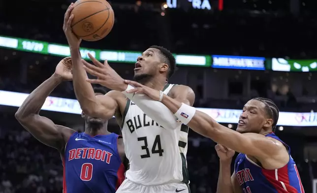 Detroit Pistons' Wendell Moore Jr. fouls Milwaukee Bucks' Giannis Antetokounmpo during the second half of an NBA basketball game Wednesday, Nov. 13, 2024, in Milwaukee. (AP Photo/Morry Gash)