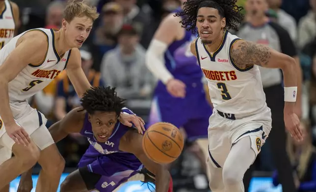 Denver Nuggets forward Hunter Tyson (5) and Utah Jazz guard Collin Sexton, middle, go for a loose ball, as Denver Nuggets guard Julian Strawther (3) looks on during the first half of an NBA basketball game Wednesday, Nov. 27, 2024, in Salt Lake City. (AP Photo/Rick Egan)