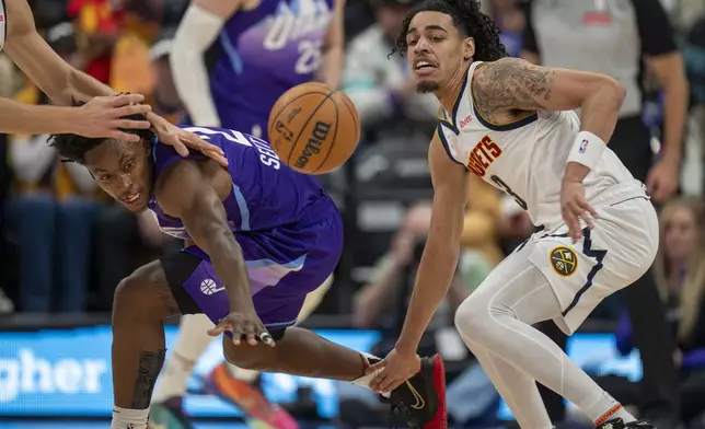 Utah Jazz guard Collin Sexton, middle, go for a loose ball, as Denver Nuggets guard Julian Strawther (3) looks on during the first half of an NBA basketball game Wednesday, Nov. 27, 2024, in Salt Lake City. (AP Photo/Rick Egan)