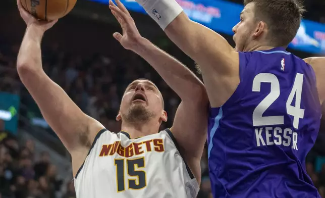 Denver Nuggets center Nikola Jokic (15) shoots as Utah Jazz center Walker Kessler (24) defends during the second half of an NBA basketball game Wednesday, Nov. 27, 2024, in Salt Lake City. (AP Photo/Rick Egan)