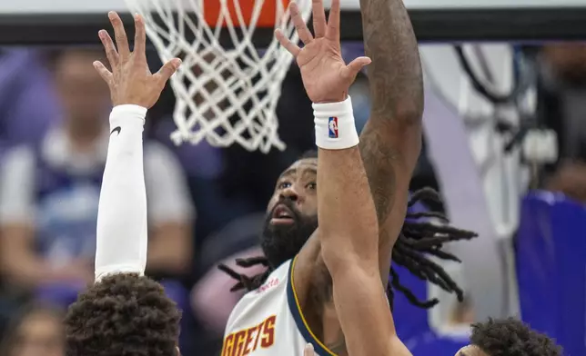 Utah Jazz guard Keyonte George (3) shoots as Denver Nuggets center DeAndre Jordan (6) and guard Julian Strawther, right, defend, during the first half of an NBA basketball game Wednesday, Nov. 27, 2024, in Salt Lake City. (AP Photo/Rick Egan)