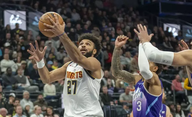 Denver Nuggets guard Jamal Murray (27) gets past Utah Jazz guard Keyonte George (3) as he goes to the hoop, during the first half of an NBA basketball game Wednesday, Nov. 27, 2024, in Salt Lake City. (AP Photo/Rick Egan)