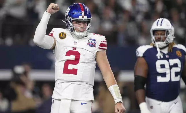 New York Giants quarterback Drew Lock (2) celebrates after running back Tyrone Tracy Jr. (29) scored a touchdown against the Dallas Cowboys during the first half of an NFL football game in Arlington, Texas, Thursday, Nov. 28, 2024. (AP Photo/Tony Gutierrez)