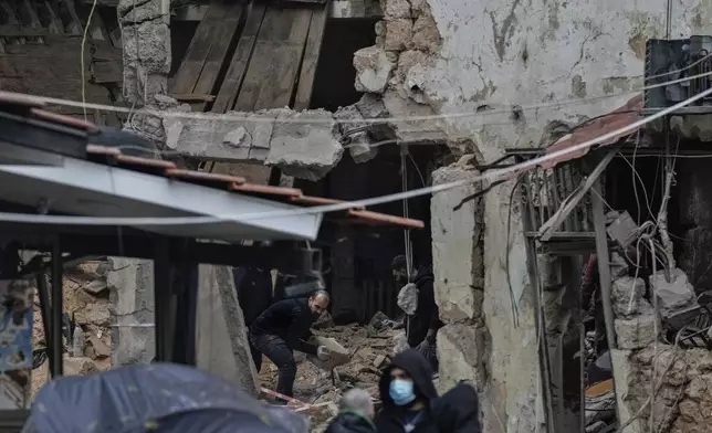 People inspect a destroyed building hit on Monday evening by an Israeli airstrike in central Beirut, Lebanon, Tuesday, Nov. 19, 2024. (AP Photo/Bilal Hussein)