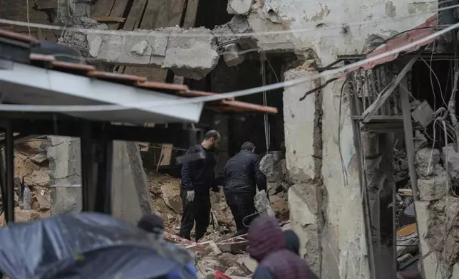 People inspect a destroyed building that was hit on Monday evening by an Israeli airstrike in central Beirut, Lebanon, Tuesday, Nov. 19, 2024. (AP Photo/Bilal Hussein)