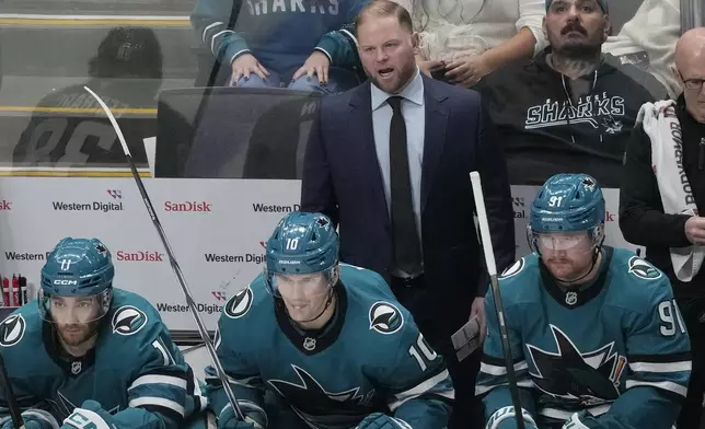 San Jose Sharks head coach Ryan Warsofsky, top middle, reacts behind players on the bench during the third period of an NHL hockey game against the Detroit Red Wings in San Jose, Calif., Monday, Nov. 18, 2024. (AP Photo/Jeff Chiu)