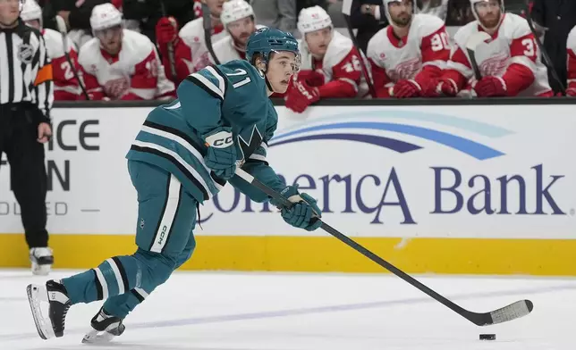 San Jose Sharks center Macklin Celebrini (71) skates with the puck against the Detroit Red Wings during the first period of an NHL hockey game in San Jose, Calif., Monday, Nov. 18, 2024. (AP Photo/Jeff Chiu)