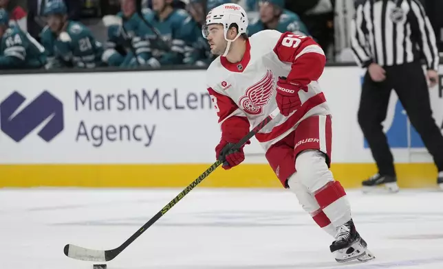 Detroit Red Wings right wing Alex DeBrincat skates with the puck against the San Jose Sharks during the first period of an NHL hockey game in San Jose, Calif., Monday, Nov. 18, 2024. (AP Photo/Jeff Chiu)